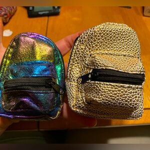 real littles backpacks X2, 10 items inside total